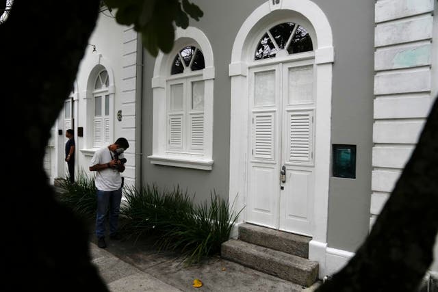 <p>A journalist films the entrance to the apartment where Brent Sikkema, an American art dealer, was found dead, in Rio de Janeiro, Brazil</p>