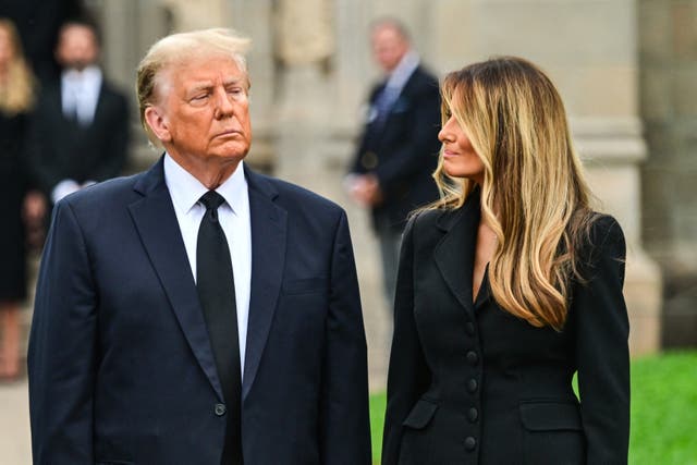 <p>Former President Donald Trump stands with his wife Melania Trump as they depart a funeral for Amalija Knavs, the former first lady’s mother</p>