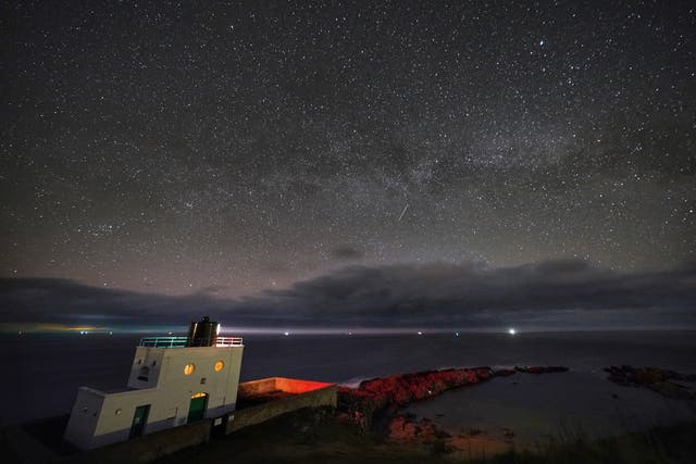 <p>The Milky Way core rises at 3am over Bamburgh Lighthouse in Northumberland</p>